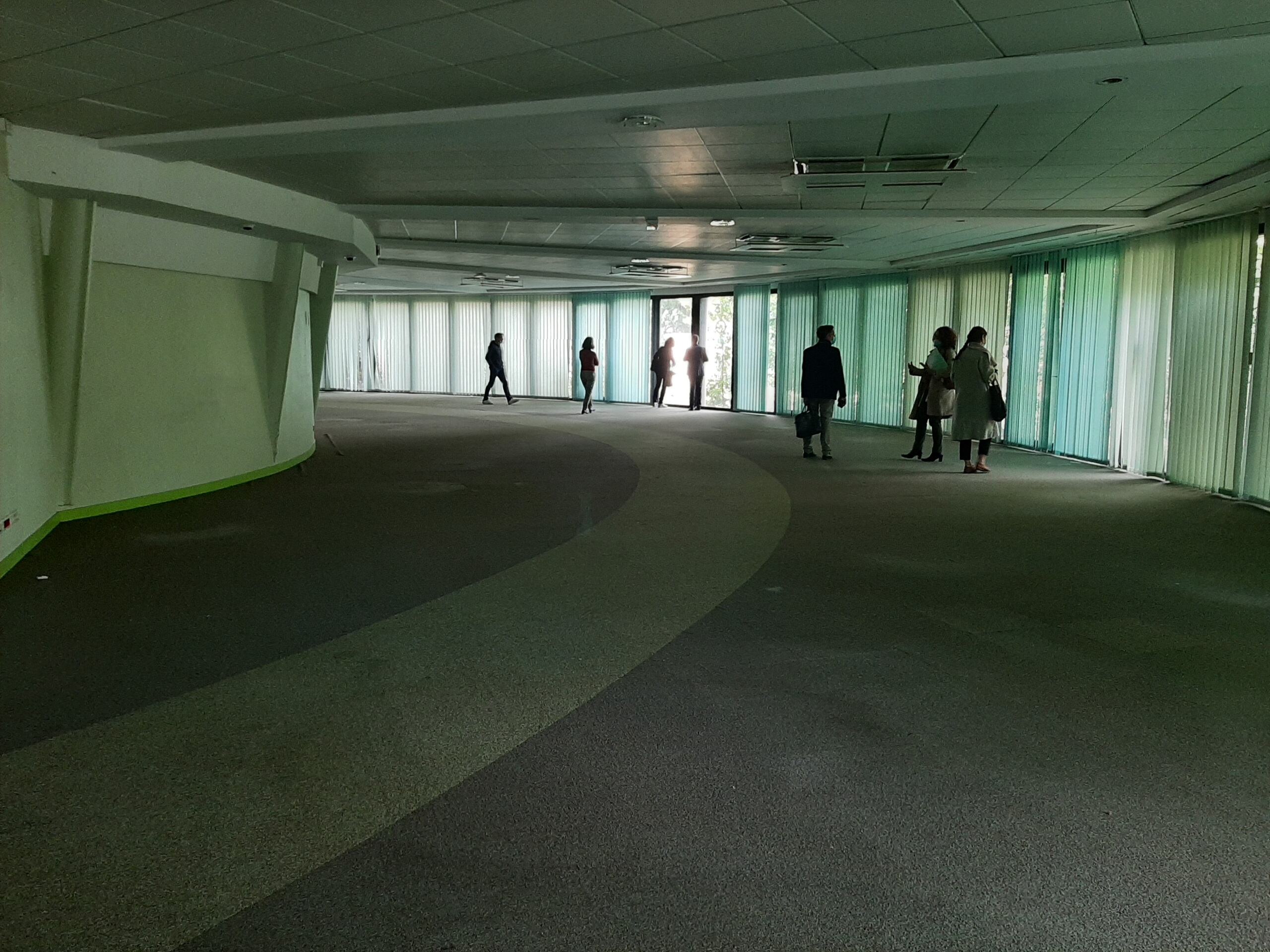 Intérieur du site Chantemerle avant travaux, vaste espace courbe traversé par plusieurs personnes