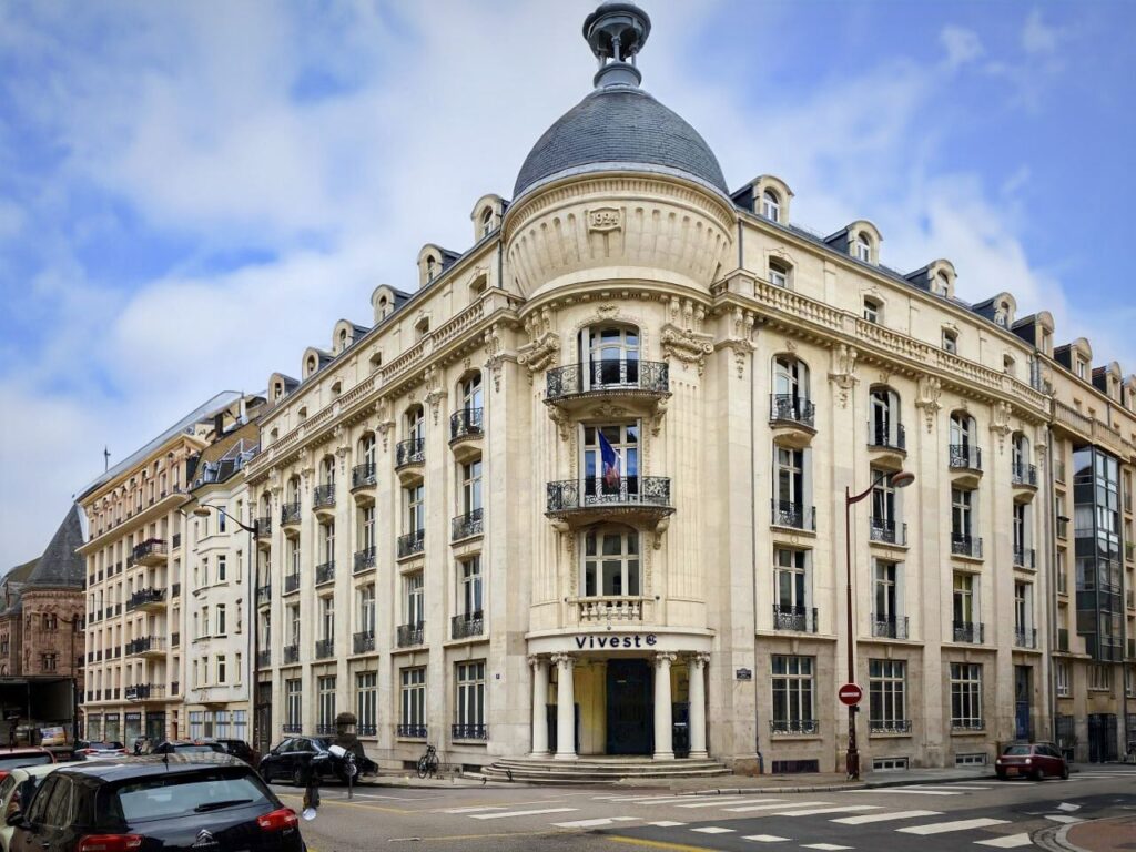 Façade d’angle de la résidence Pasteur dans un immeuble historique aux décors sculptés