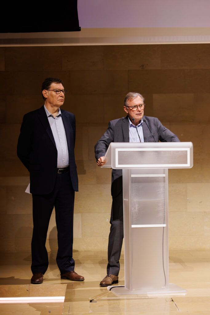 Deux intervenants, dont l’un au pupitre, lors du Sommet de la Transformation à Paris en novembre 2025