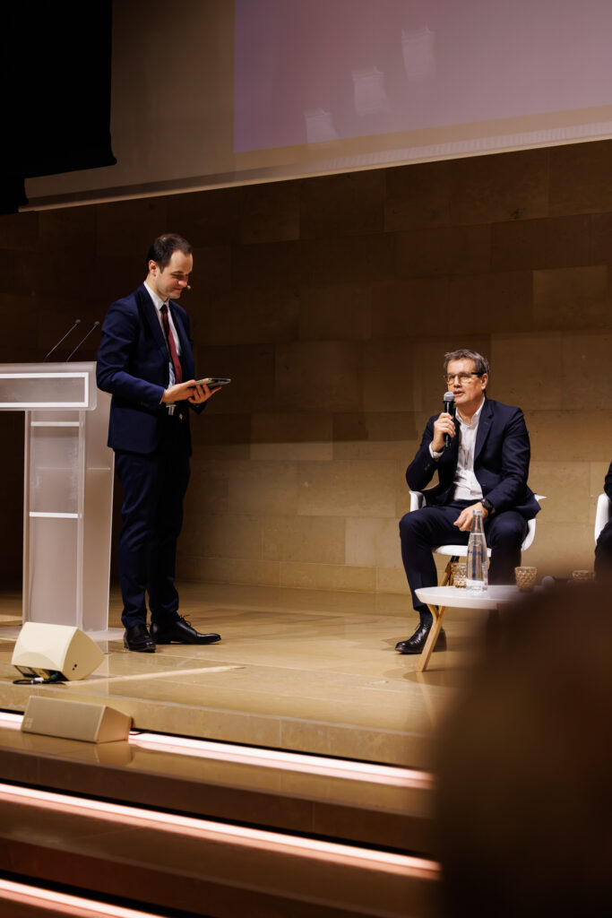 Deux intervenants échangent sur scène au Sommet de la Transformation au 3 Mazarium à Paris, novembre 2025